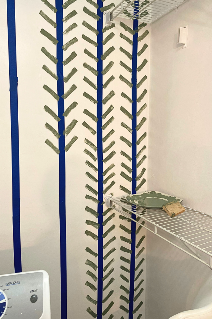 How to do laundry room makeover diy.Applying the sponge to the wall to create herringbone pattern. Tap on the wall, don't use too much of the paint so it's not dripping.