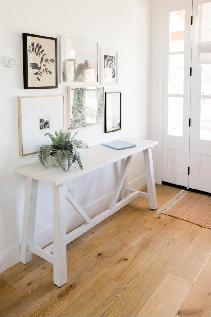 Mixing modern and old can be done in any room. Vintage table gets a proper look when pictures above it are having more crisp and modern look.